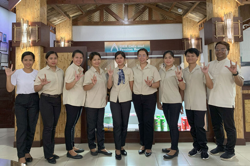Friendly IDEA staff at the pension house front desk, ready to welcome guests